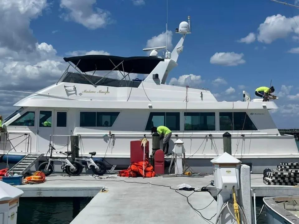 Boat canvas and enclosure being cleaned dockside